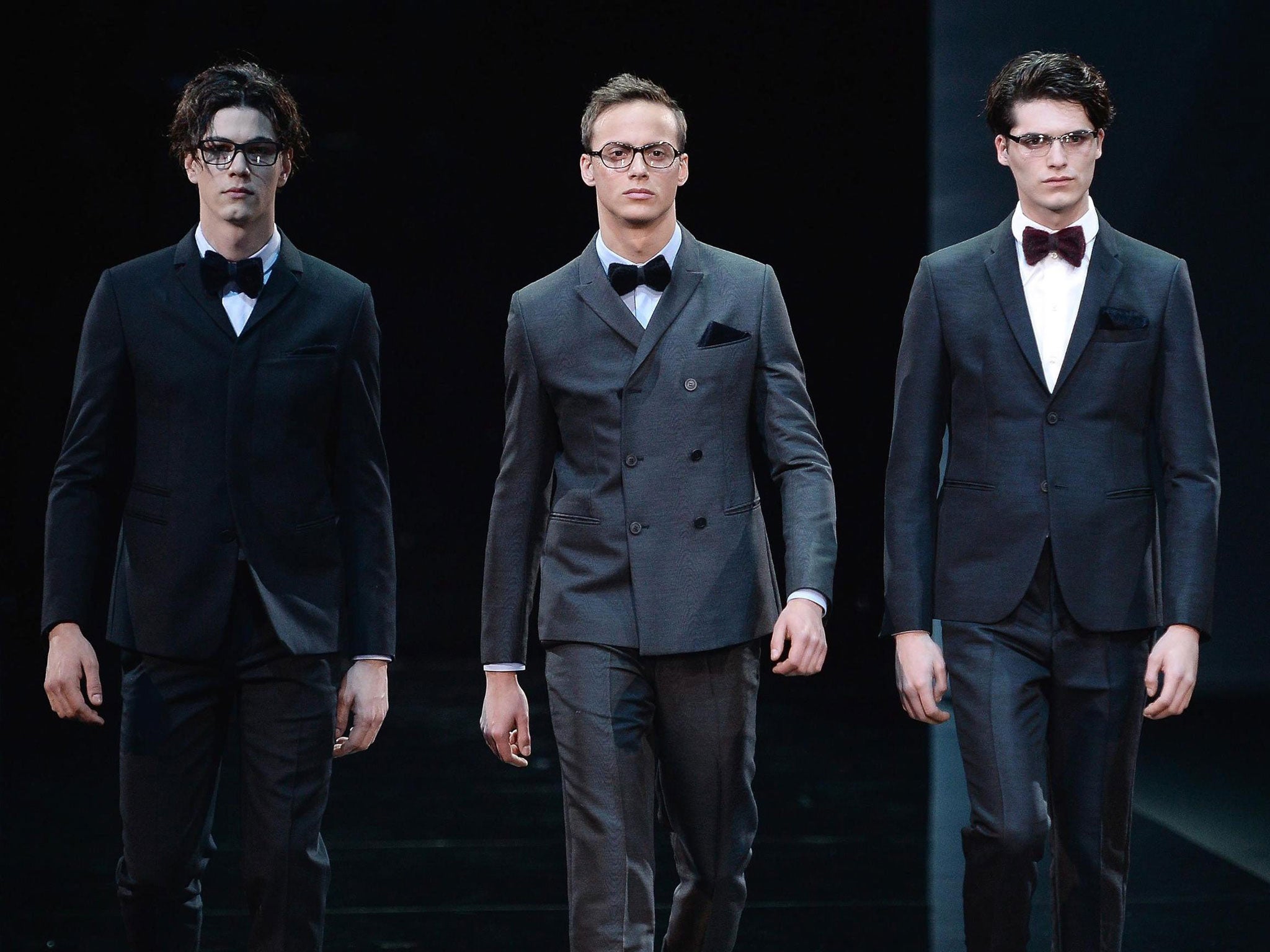 Models present creations by Emporio Armani at the Fall/Winter 2014 Men's collection