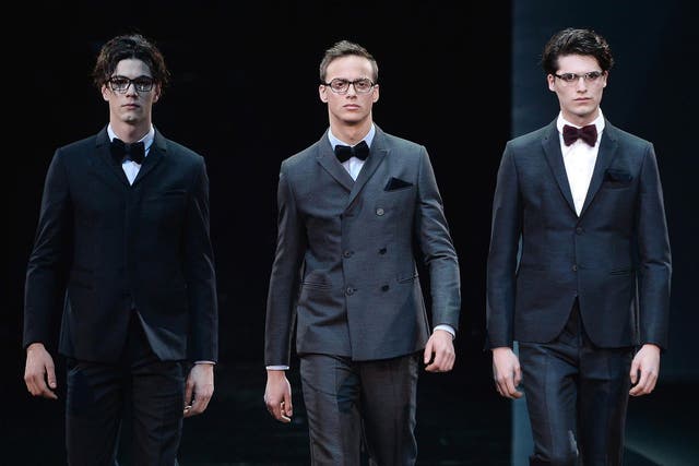 Models present creations by Emporio Armani at the Fall/Winter 2014 Men's collection