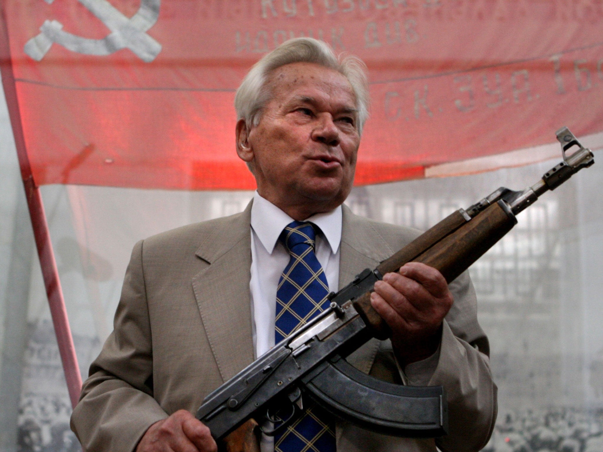 Mikhail Kalashnikov posing with the first model of his legendary AK-47 - he died on 23 December, 2013 at the age of 94