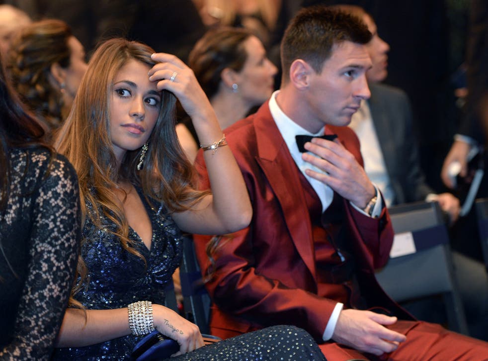 Barcelona's Argentine forward Lionel Messi (R) and his partner Antonella Roccuzzo attend the 2013 FIFA Ballon d'Or award ceremony at the Kongresshaus in Zurich