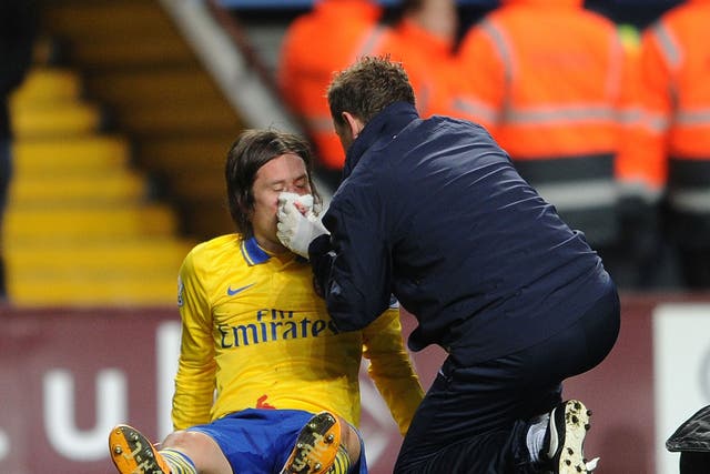 Tomas Rosicky receives treatment after catching a stray elbow off Aston Villa striker Gabriel Agbonlahor during Arsenal's 2-1 victory