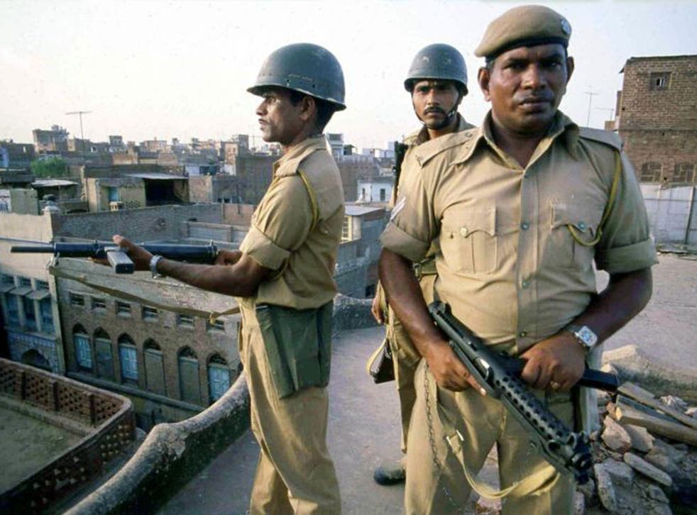 In this file photo from 6 June, 1984, Indian troops take up position on rooftops around the Golden Temple in Amritsar