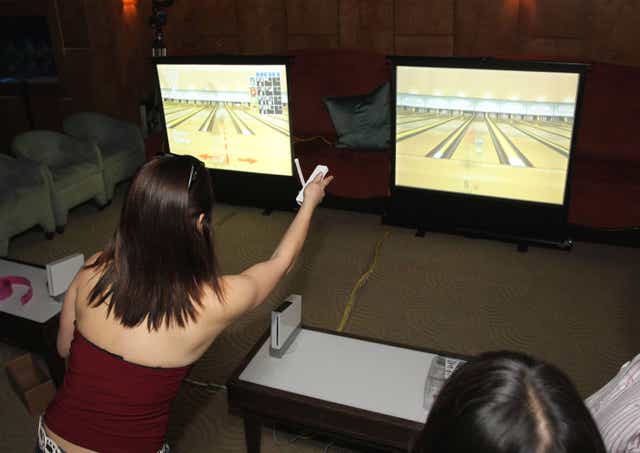 Gamers in California using the Wii console as entertainment to play Wii Bowling.