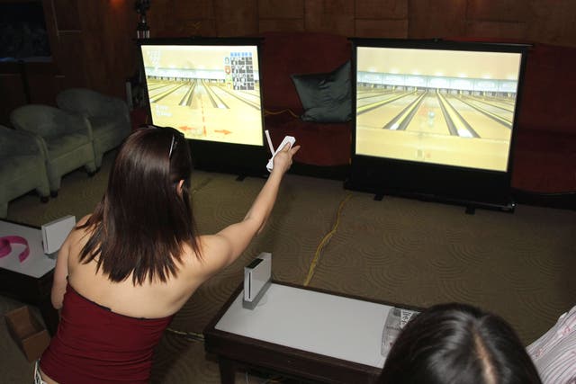 Gamers in California using the Wii console as entertainment to play Wii Bowling.
