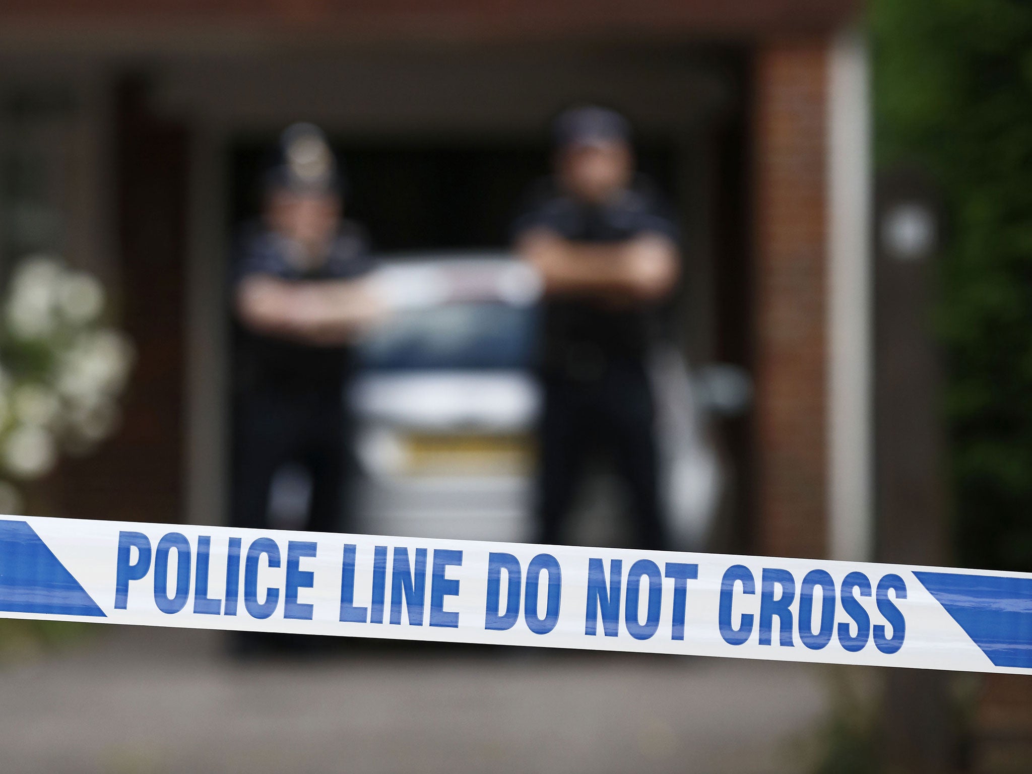 Police stand outside the home of Saad and Iqbal al-Hilli in Claygate, Surrey, in 2012 during the investigation into their death in the French Alps.