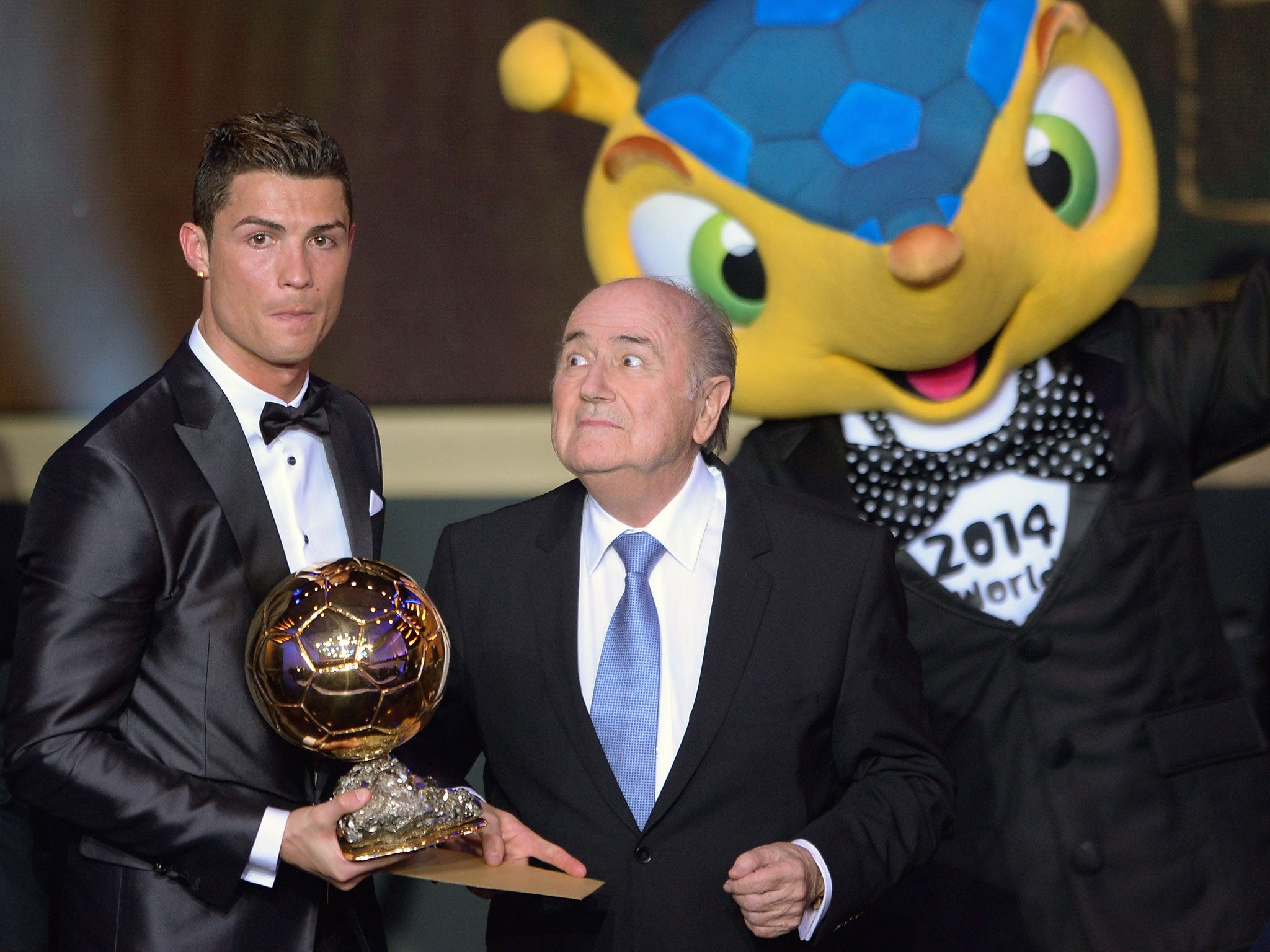 Real Madrid's Portuguese forward Cristiano Ronaldo (L) poses with his Ballon d'Or