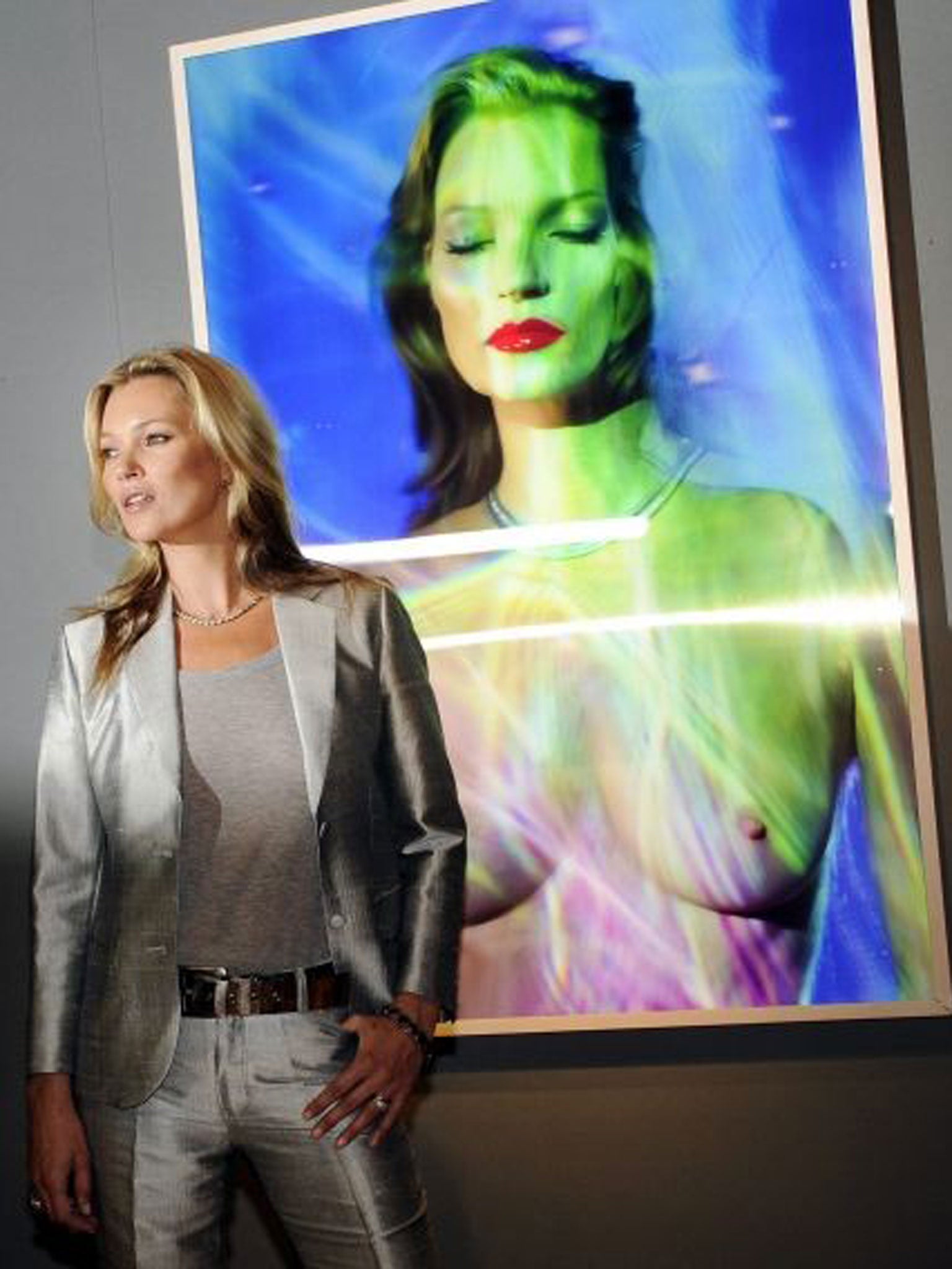 Kate Moss posing next to 'She's Light' by artist Chris Levine during a press view