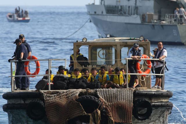 A barge carries asylum-seekers bound for detention centres on Christmas Island after their boat was intercepted