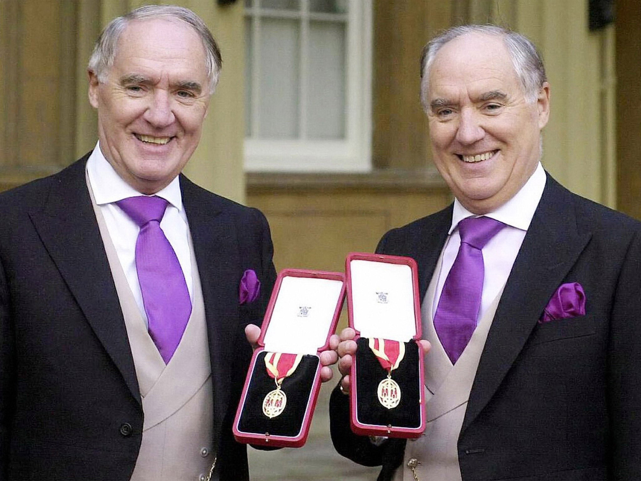 Sir David Barclay (left) and his twin brother Sir Frederick after they received knighthoods (Getty)