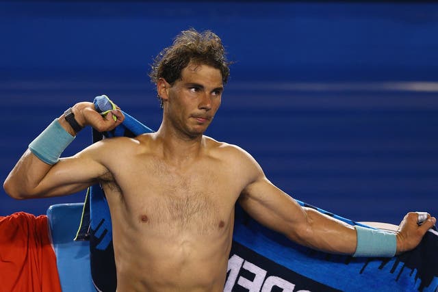 Rafael Nadal tries to cool himself down while on court at the Australian Open