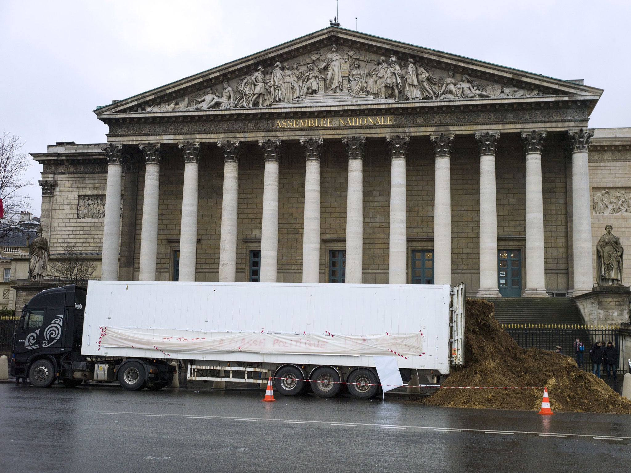 This truck dumped manure outside of the French National Assembly