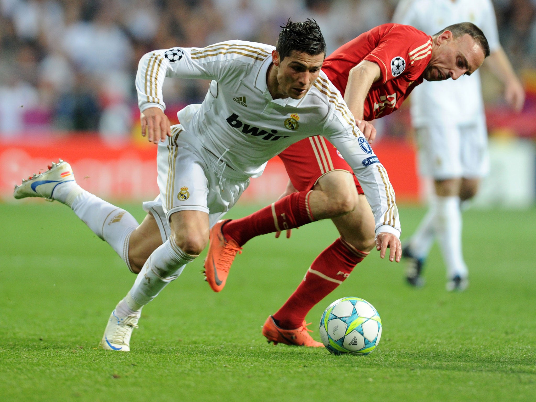 Cristiano Ronaldo and Franck Ribery jostle for the ball during Real Madrid's match against Bayern Munich