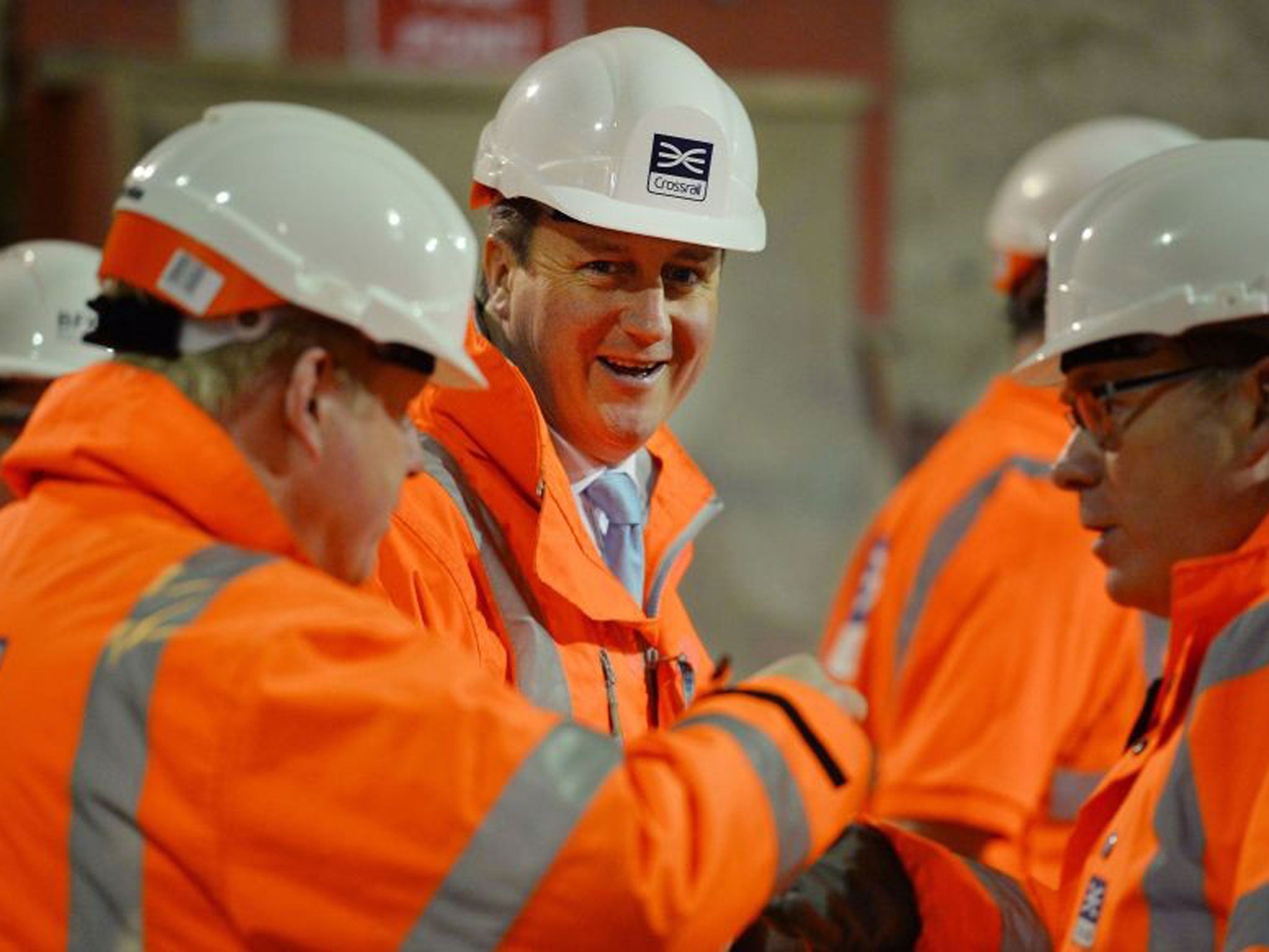 David Cameron smiles as he visits a Crossrail construction site underneath Tottenham Court Road