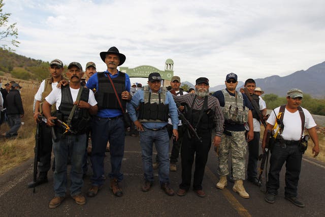 Dr Jose Manuel Mireles (third left), one of the leaders of the Michoacan vigilante group pictured with him. He has since been injured in an aircrash that could have been an attempt on his life