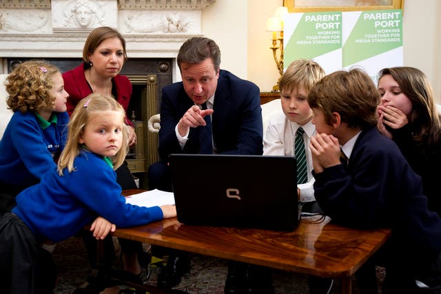 British Prime Minister David Cameron (C) and Children's Minister Sarah Teather (2nd L) pose with children as they view a new ParentPort website at 10 Downing Street on October 11, 2011in London, England.