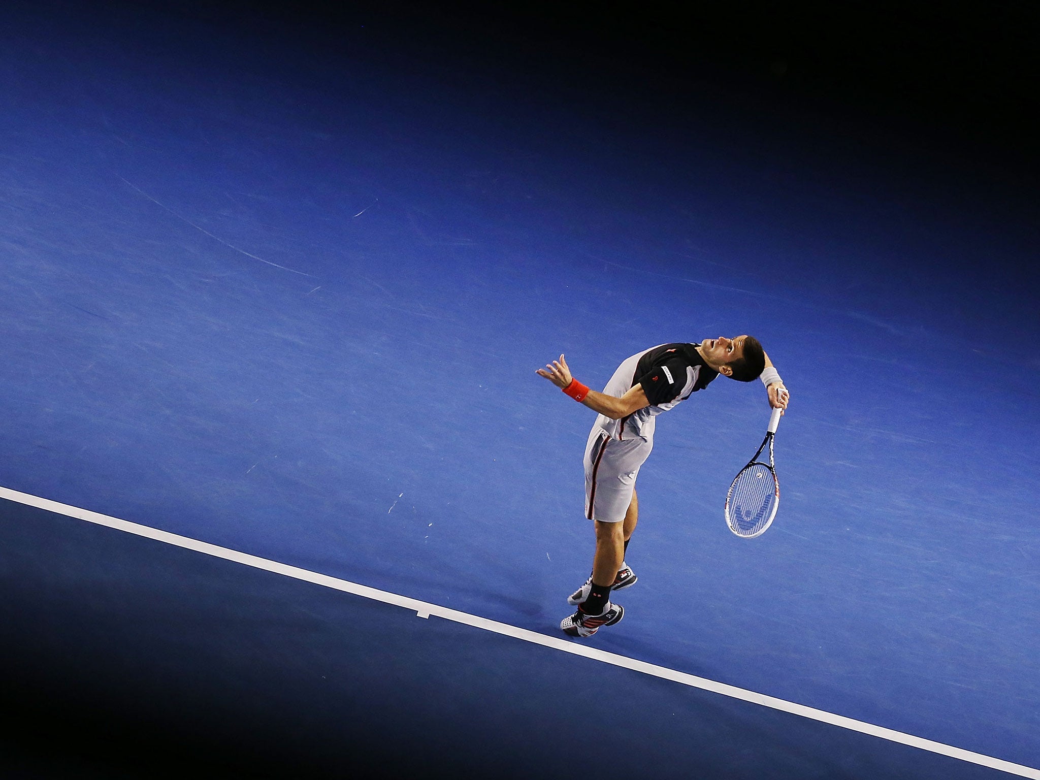 Novak Djokovic of Serbia serves in his third round match against Denis Istomin of Uzbekistan