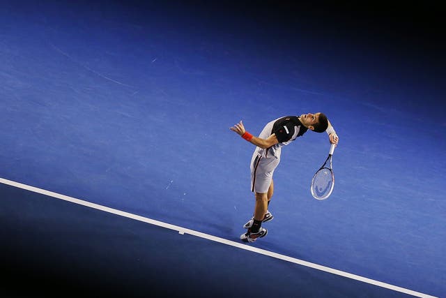 Novak Djokovic of Serbia serves in his third round match against Denis Istomin of Uzbekistan