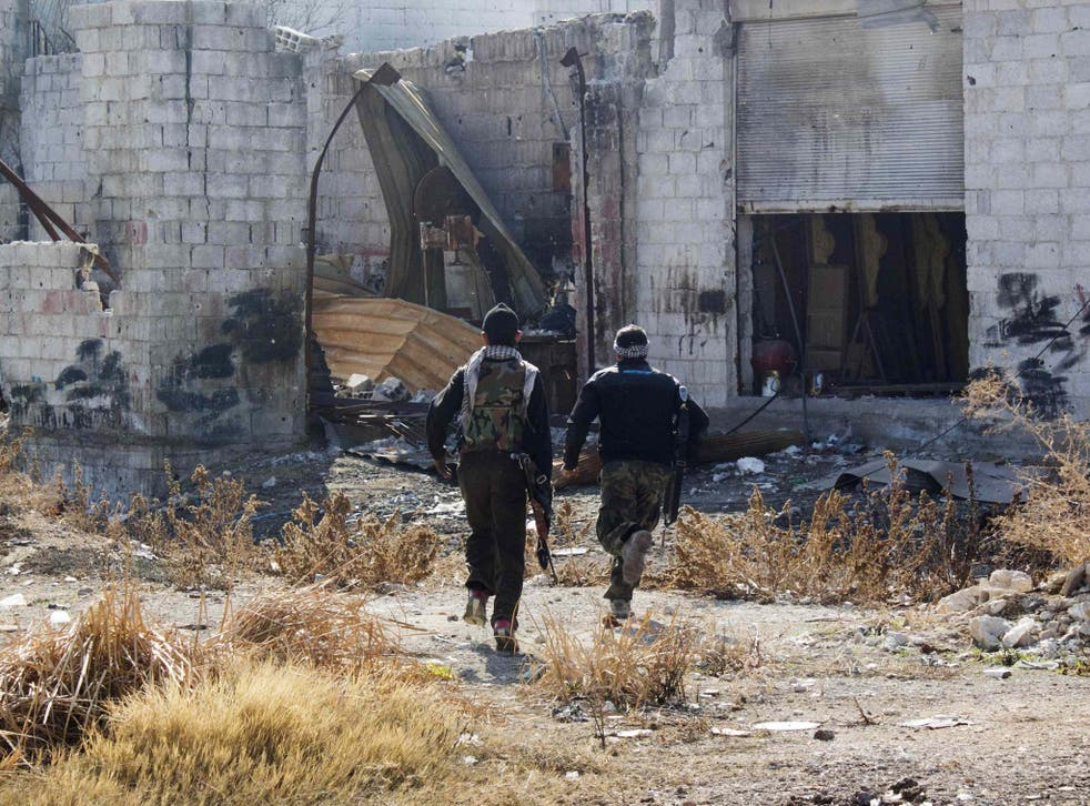 Free Syrian Army fighters carry their weapons as they run for cover in Daraya, near Damascus; Syamend Farhan says he is just happy to have escaped the terror of Syria