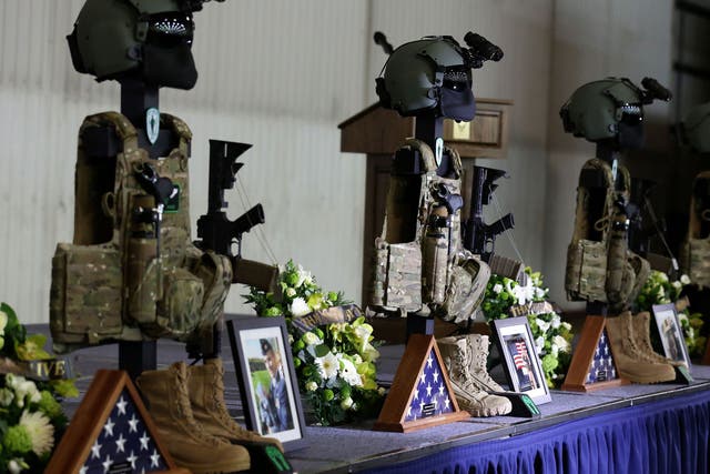 The dog tags rifles and body armour of the fallen Airmen of the United States Air Force 56th Rescue Squadron during a memorial service at RAF Lakenheath, who died when their Pave Hawk helicopter crashed on 7 January