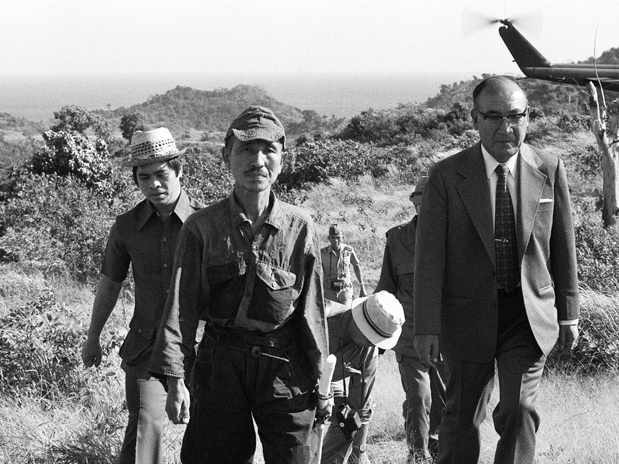 March 1974: Hiroo Onoda (2nd left) walking from the jungle where he had hidden since World War II. Onoda has died at the age of 91