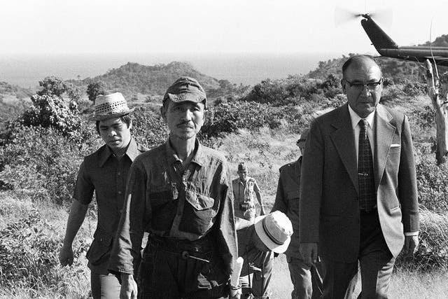 March 1974: Hiroo Onoda (2nd left) walking from the jungle where he had hidden since World War II. Onoda has died at the age of 91