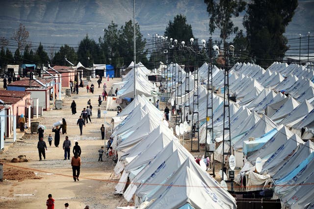 Syrian refugees walk among tents at Karkamis' refugee camp near the town of Gaziantep, south of Turkey