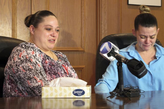 Amber McGuire, left, recounts the execution of her father, Dennis McGuire, as her sister-in-law Missie McGuire cries at a news conference Friday in Dayton, Ohio