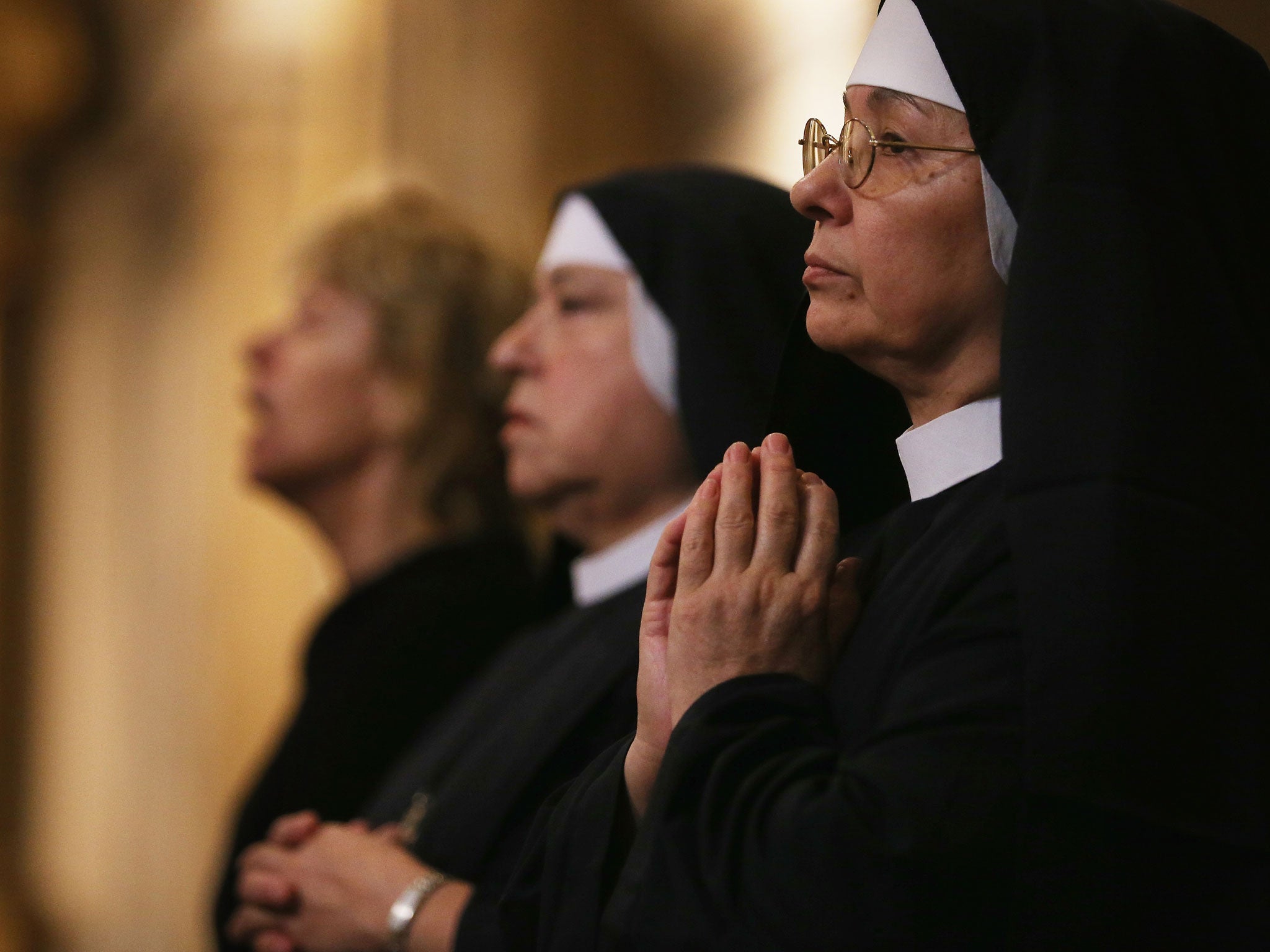 Nuns worship in the Metropolitan Cathedral during Mass on the day after Pope Francis was elected at the conclave on 14 March 2013