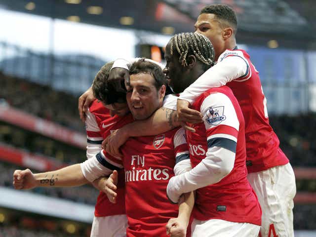 Santi Cazorla celebrates with his Arsenal teammates after scoring against Fulham