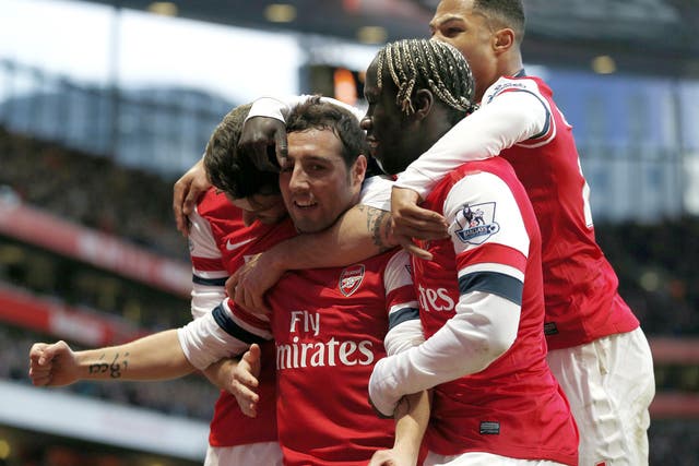 Santi Cazorla celebrates with his Arsenal teammates after scoring against Fulham