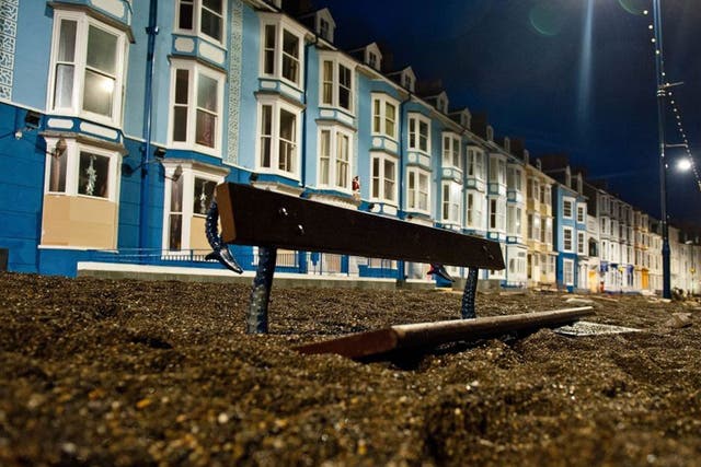 Heavy weather: Sea debris fills a street in Aberystwyth, west Wales, after ferocious storms earlier this month