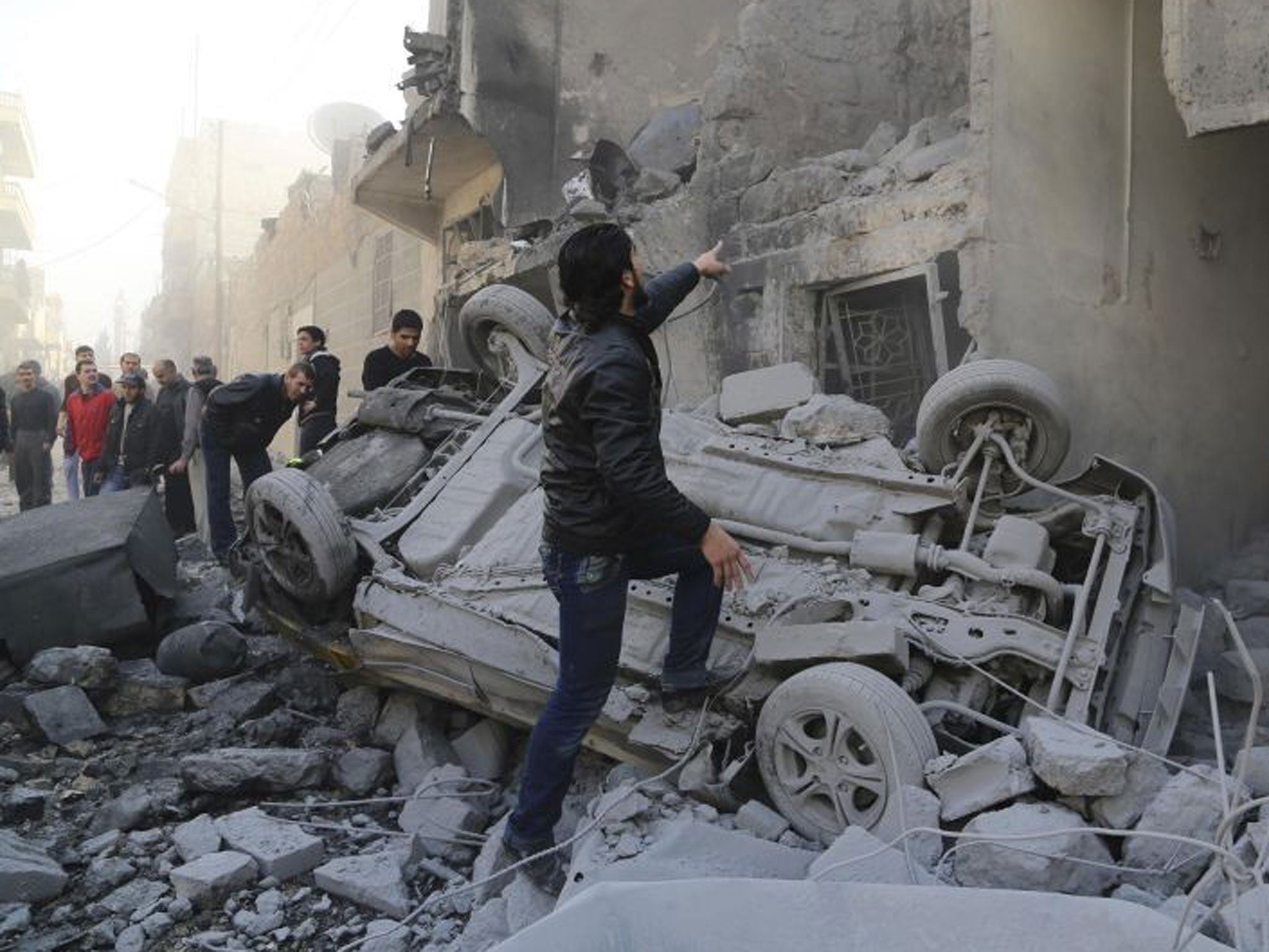 Shattered: The search for survivors begins after an airstrike yesterday in Aleppo