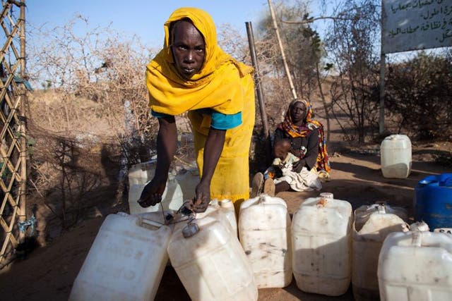 What about Darfur? A woman with empty jerry cans for water leaving a camp for Internally Displaced Persons 