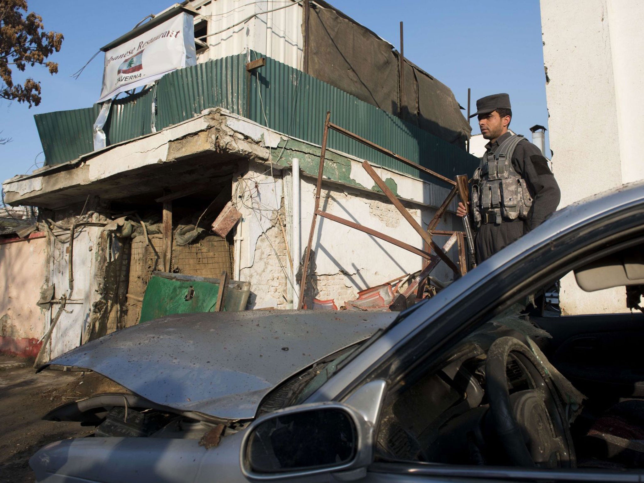 Carnage: A Kabul policeman surveys the damage