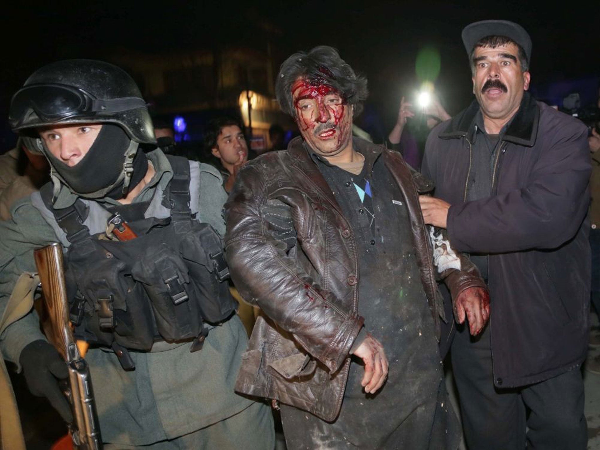 Police help an injured victim of the attack