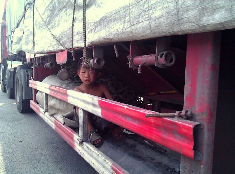 A scared boy of five found under a lorry in China