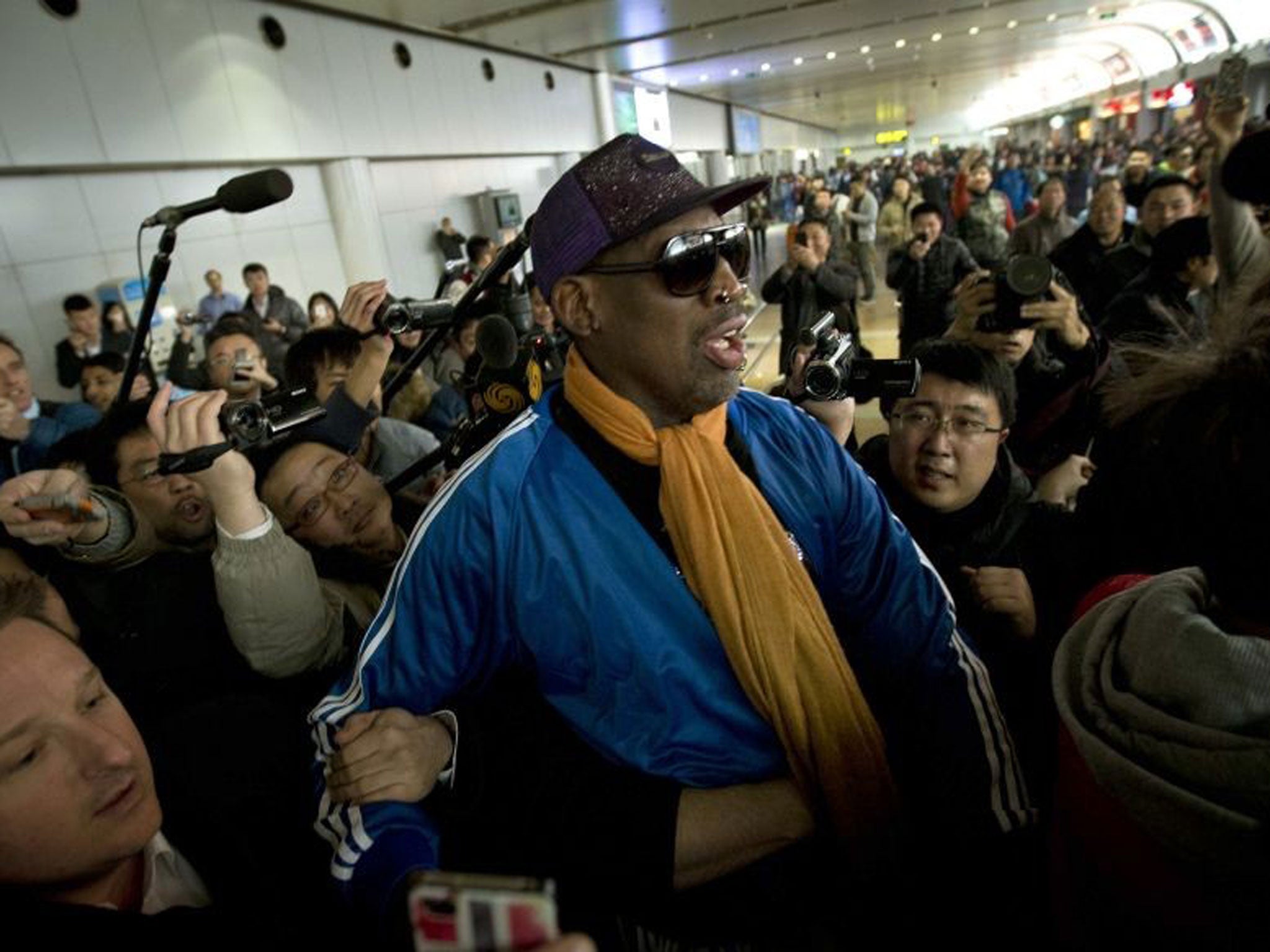 Former NBA star Dennis Rodman, here being mobbed on his arrival in Beijing from Pyongyang on Monday 13 January, has been checked into an undisclosed alcohol rehab centre following his return from North Korea