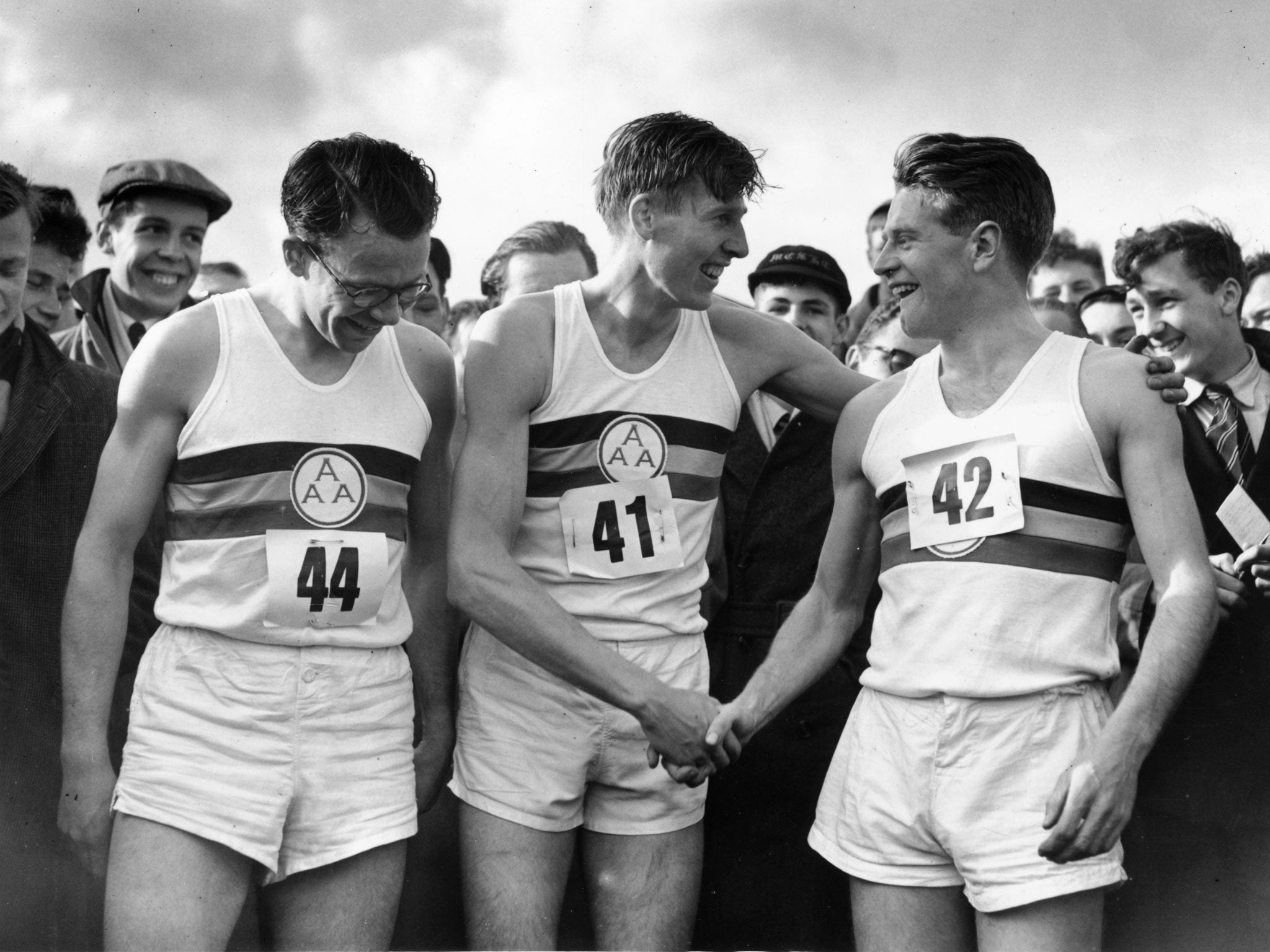 Sir Chris (right) congratulates Roger Bannister (centre) on setting a new record for running the mile in 3 minutes 59.4 seconds