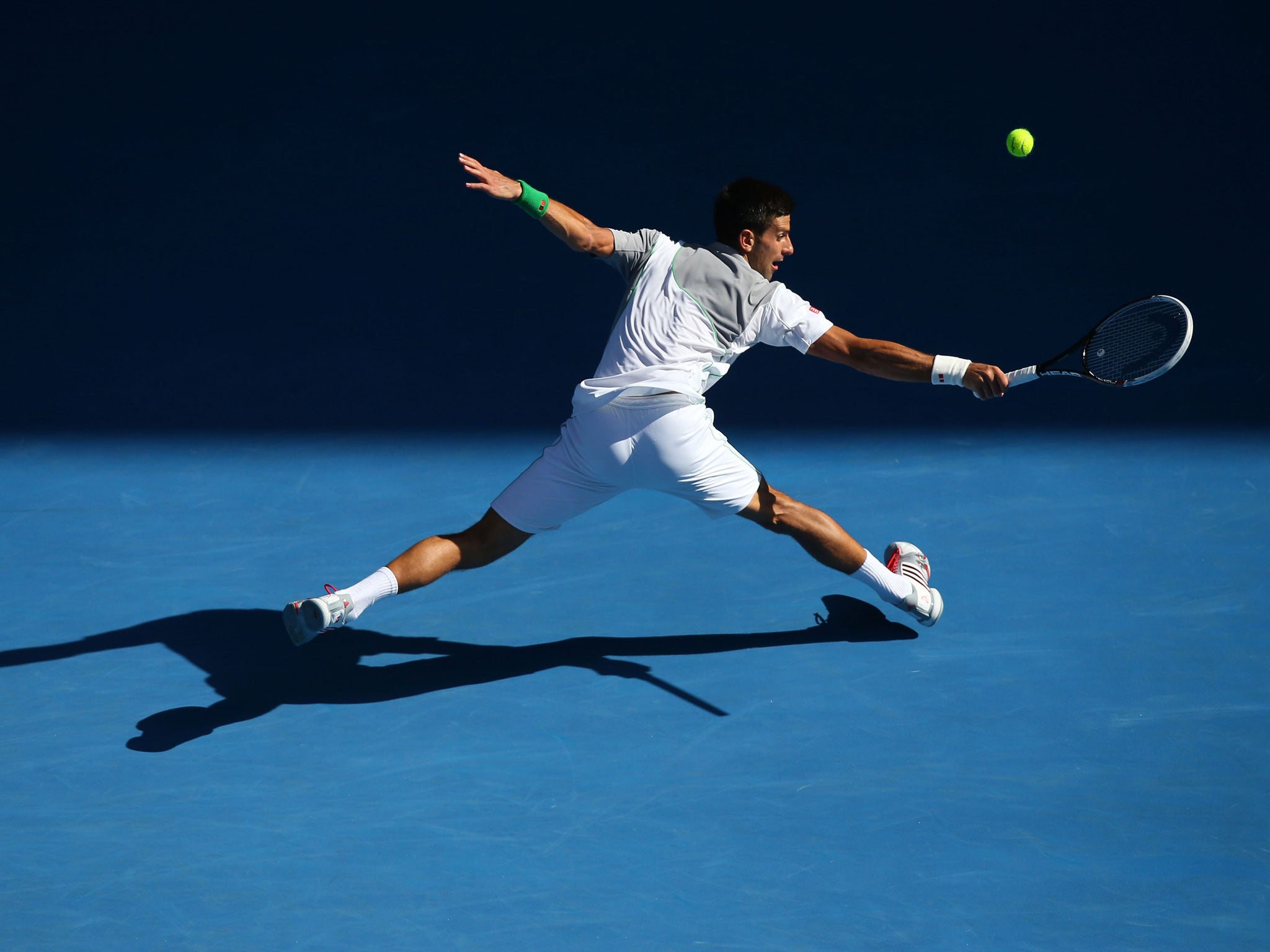 Novak Djokovic retrieves a backhand on his way to victory