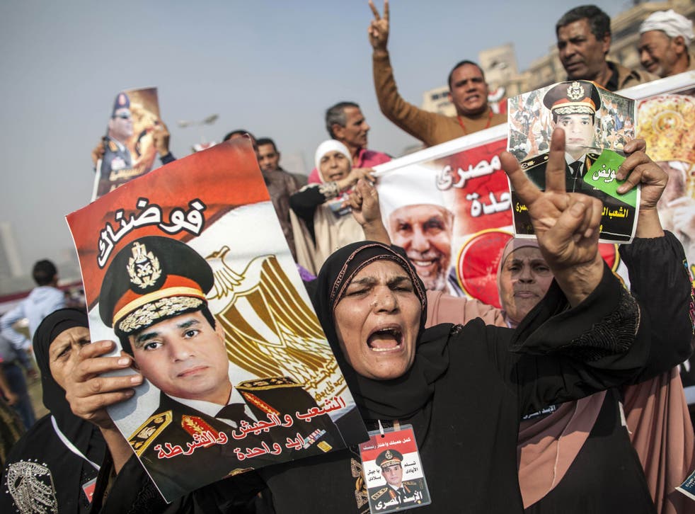 Supporters of Egypt's military chief Abdel Fattah al-Sisi hold his portrait on November 19, 2013
