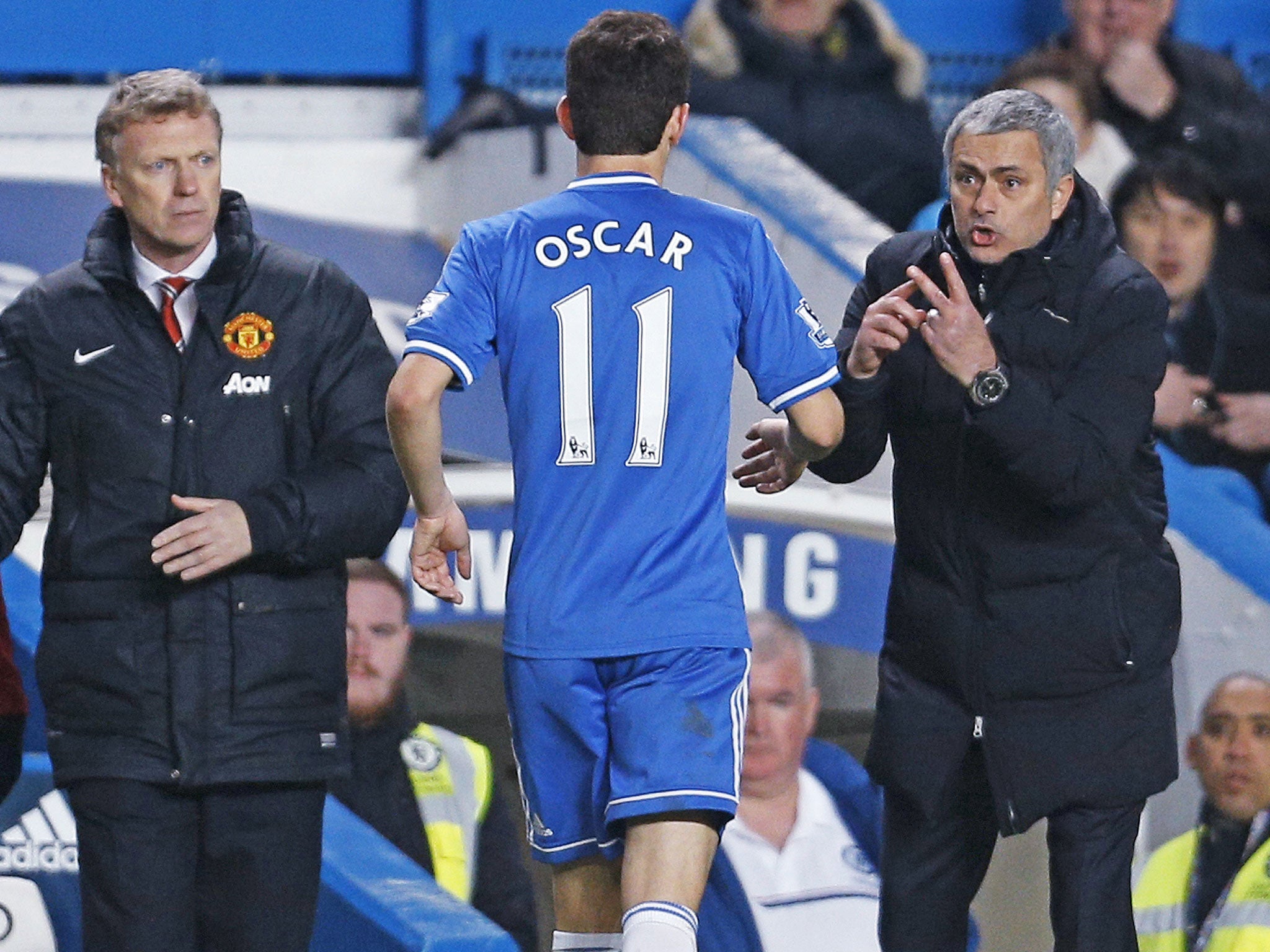 David Moyes looks on as Jose Mourinho gives instructions to Oscar