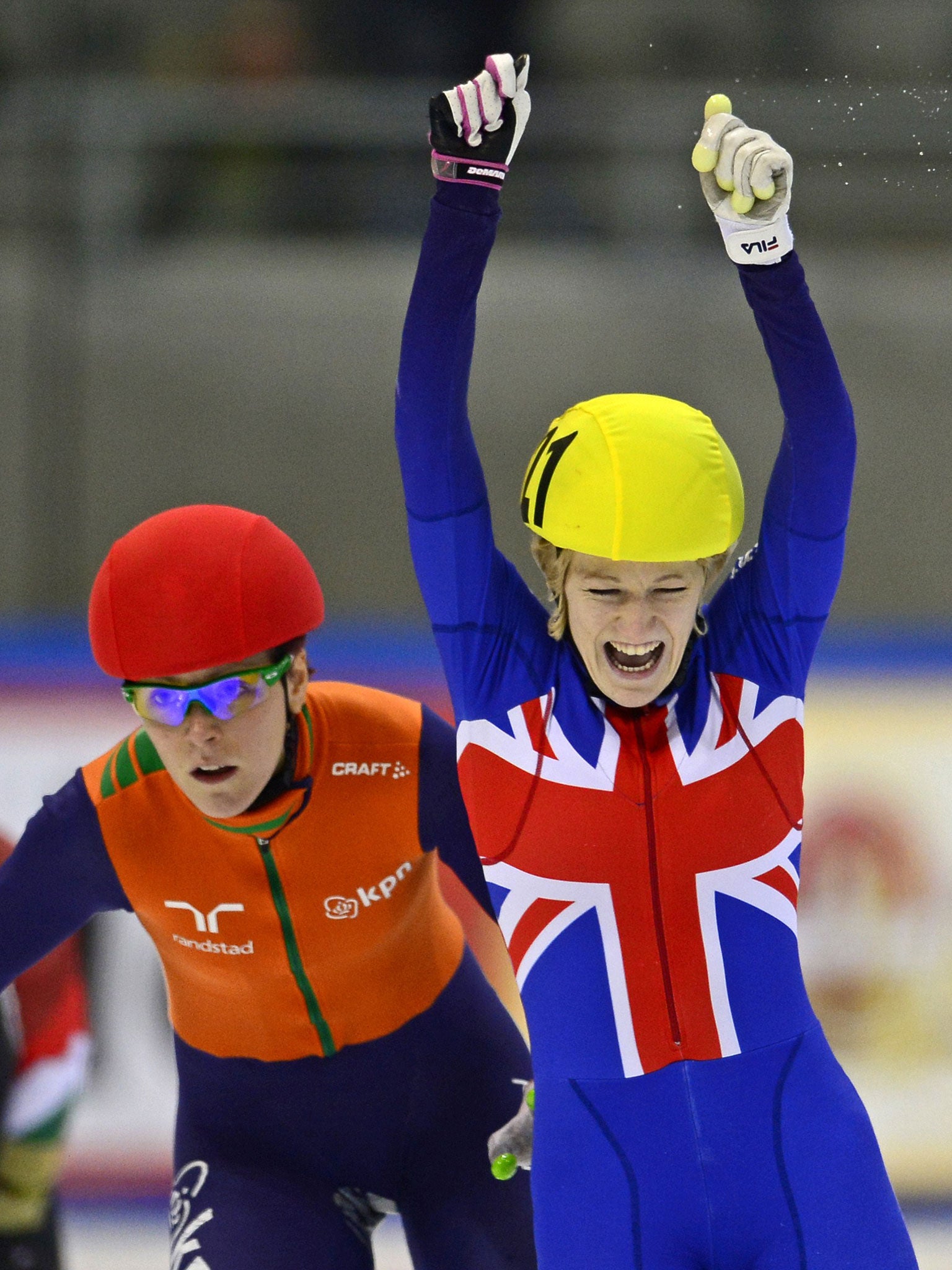 Elise Christie raises her arms in triumph after winning the European 1,000m final