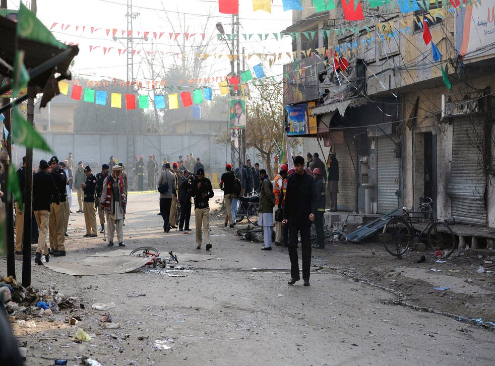 Pakistani security officials inspect the site of a suicide bomb attack in Rawalpindi, on Monday.