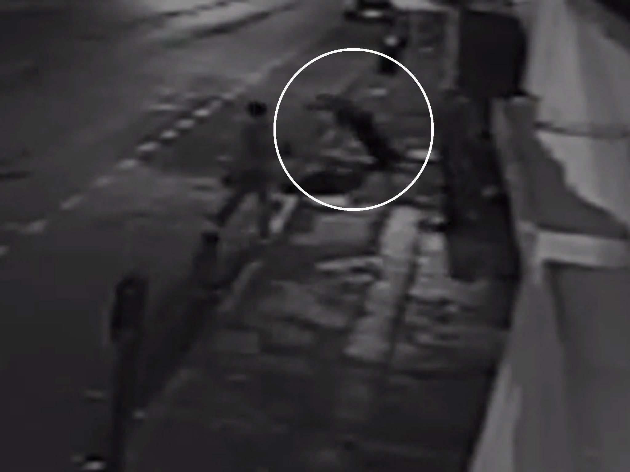 The moment the man falls to the ground after he is knocked unconscious by a mugger