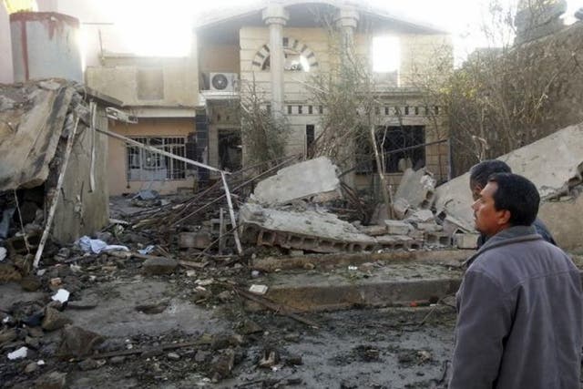 Civilians at the site of a car bomb attack in the town of Tuz Khurmatu, north of Baghdad 