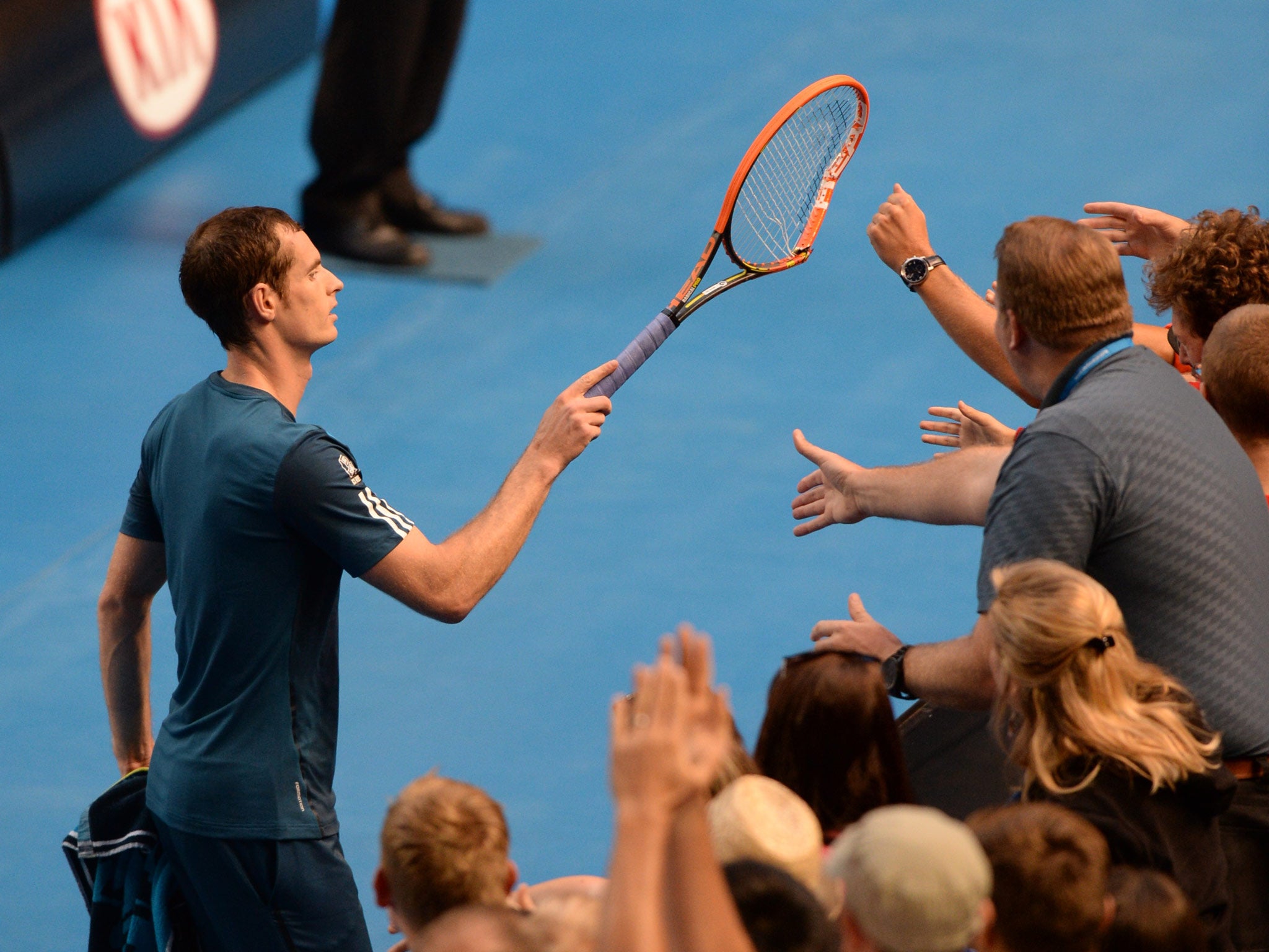 Andy Murray gives away his racket which he broke during his victory over Stephane Robert