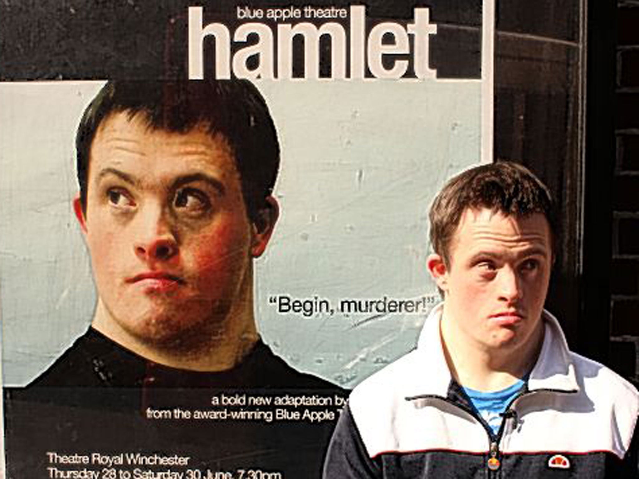 Tommy in front of his picture on a poster for 'Hamlet'