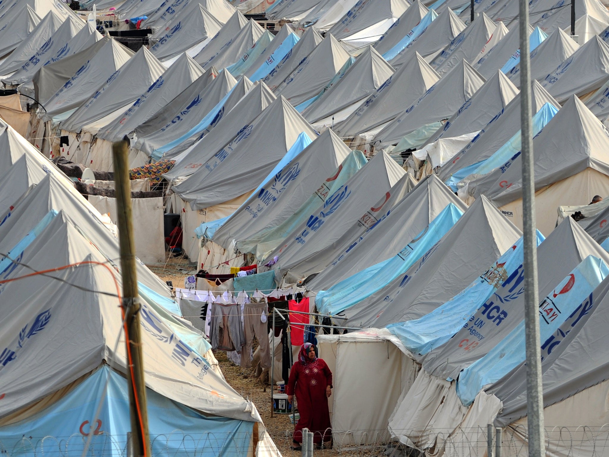 A Syrian refugee woman walks among tents at Karkamis' refugee camp (AFP/Getty)