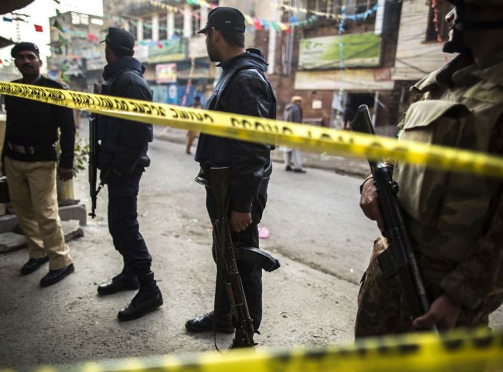Security officials cordon off the site of a suicide blast in Rawalpini where 13 people died. The Pakistani military launched air strikes against suspected Taliban hideouts on the Afghan border, on the night of the 21 January.