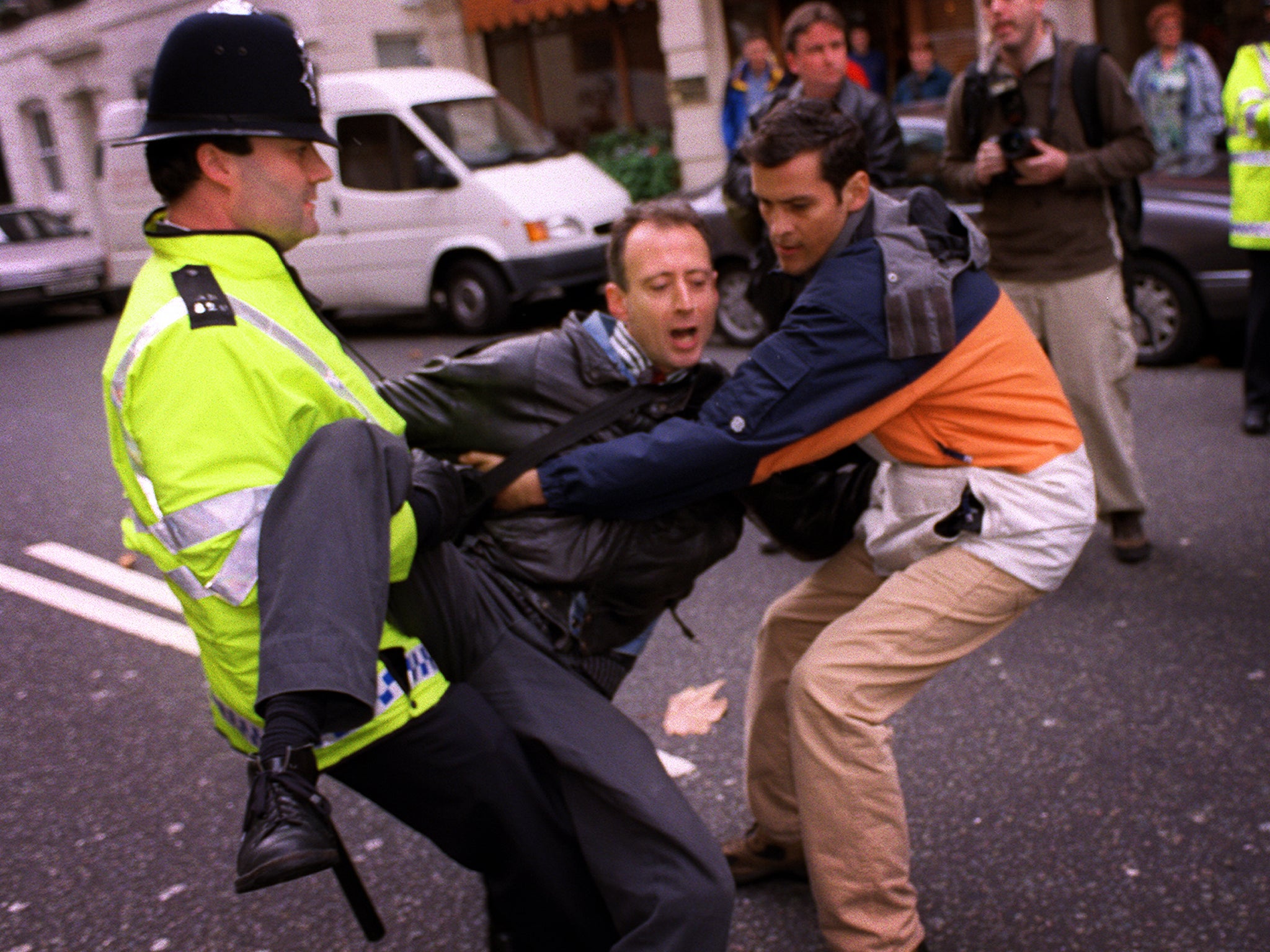 A rights tussle: Peter Tatchell attempts to arrest Robert Mugabe in 1999, in London